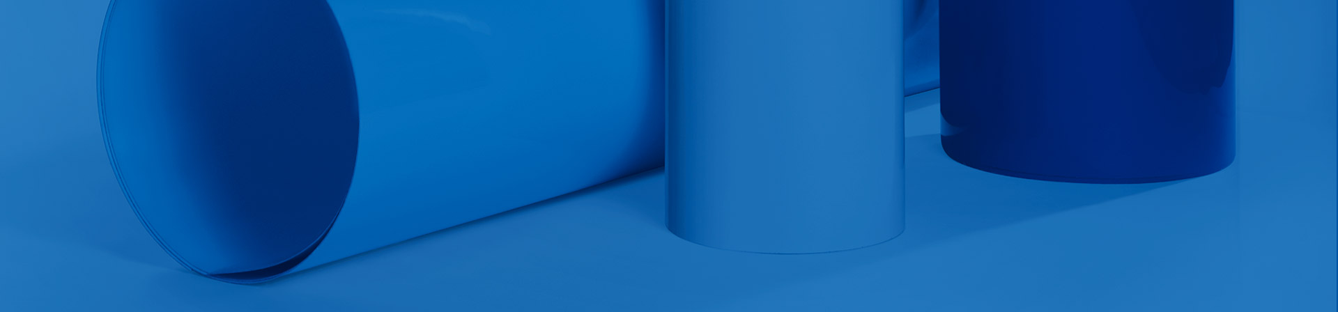 rolls and sheets of fiberglass laminates in blue tint on blue background